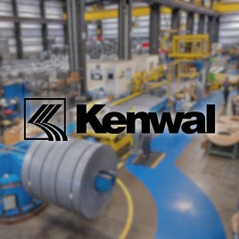 A blurred Kenwal steel facility photo with kenwal steel logo in the middle of the image.