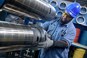 A Kenwal Steel employee dressing a precision slitting head.