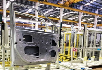 Side view of the interior of a car door being manufactured in one of Kenwal’s pristine steel processing and distribution centers.