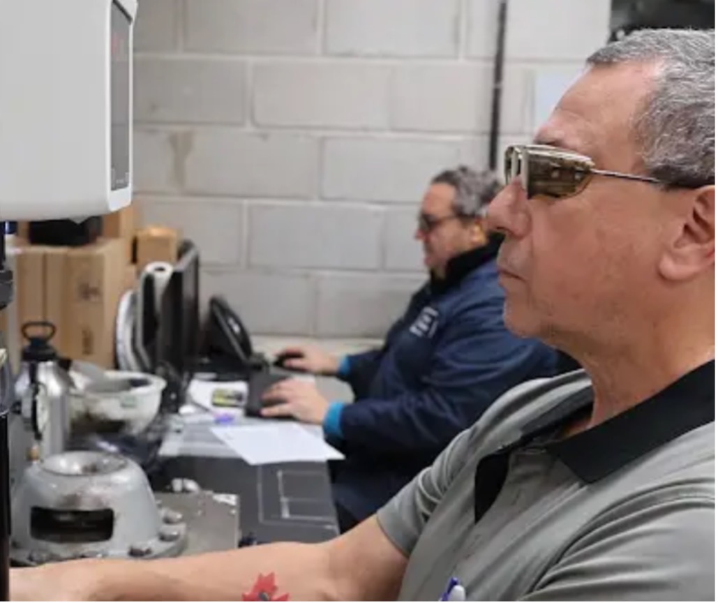 Metallurgists at Kenwal Steel inspecting steel quality inside their steel service facility’s lab.