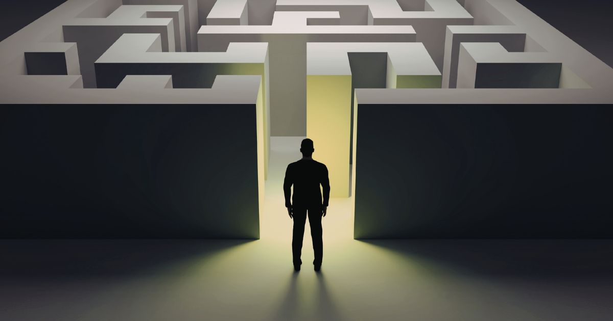 A silhouette of a person standing in front of a maze representing a potential steel client navigating the process of choosing the right steel coil supplier.